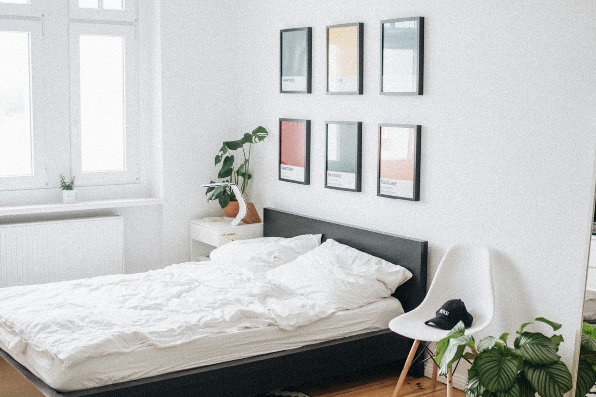 black platform bed with white mattress inside bedroom