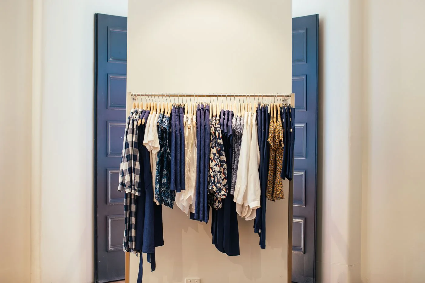 Clothing neatly arranged on hangers on a rack